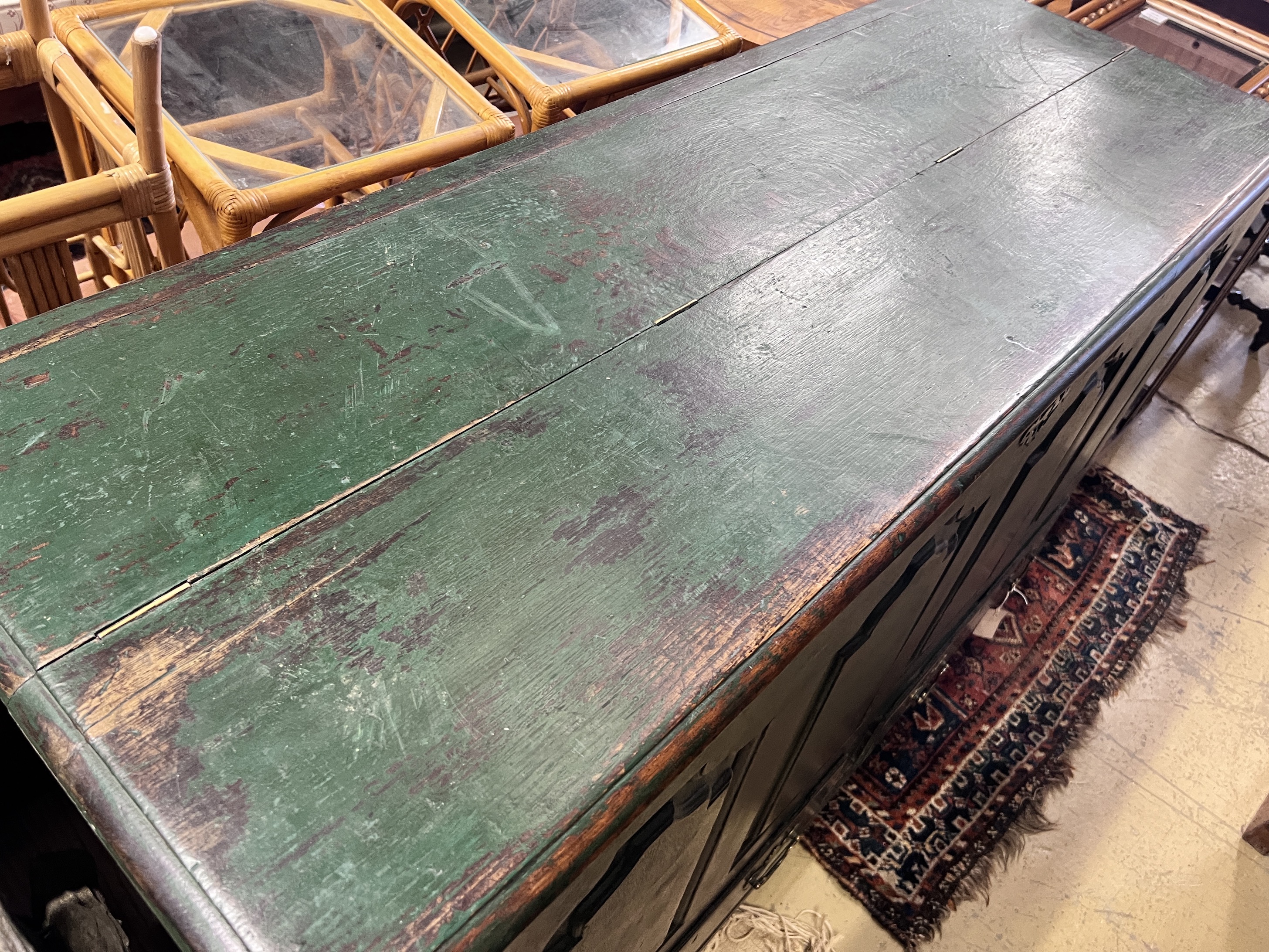 An 18th century panelled oak mule chest with later green paintwork, width 150cm, height 95cm